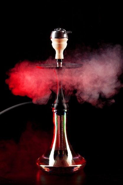 Smoking hookah on black background