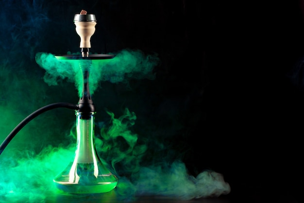 Smoking hookah on black background