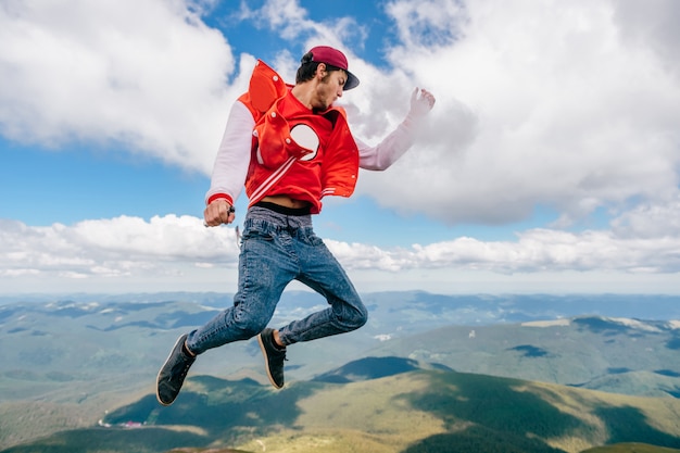 smoking man jumping in mountains