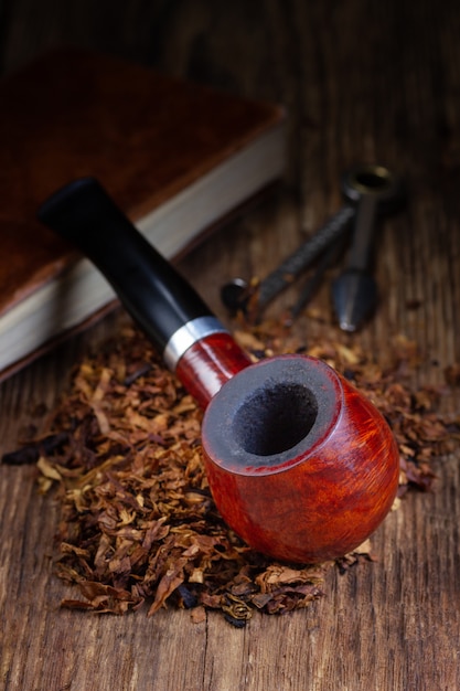 Smoking pipe and tobacco pile.