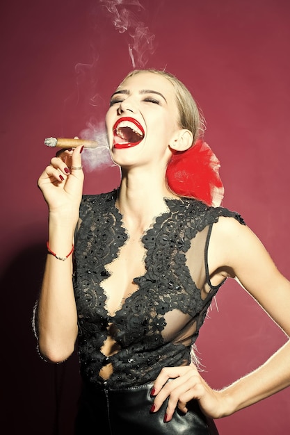 Smoking woman in black lace retro clothing and red bow