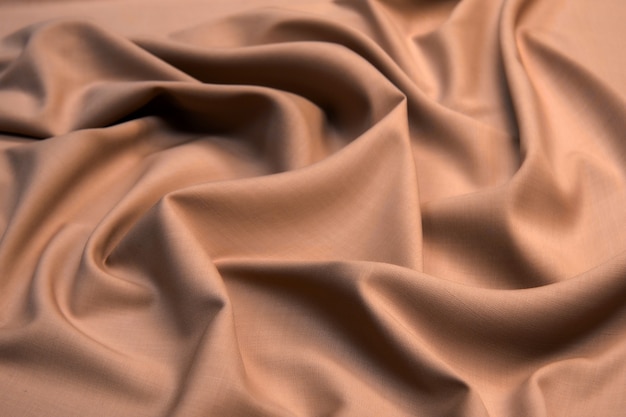 Smooth elegant brown silk satin textured fabric for using as abstract for design.