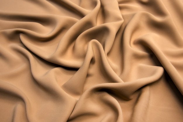 Smooth elegant brown silk satin textured fabric for using as abstract for design.