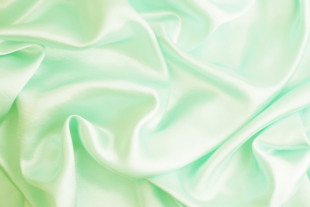 Smooth elegant green silk or satin texture can use as abstract background