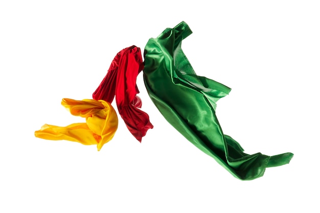 Smooth elegant transparent yellow, red, green cloth separated on white background.