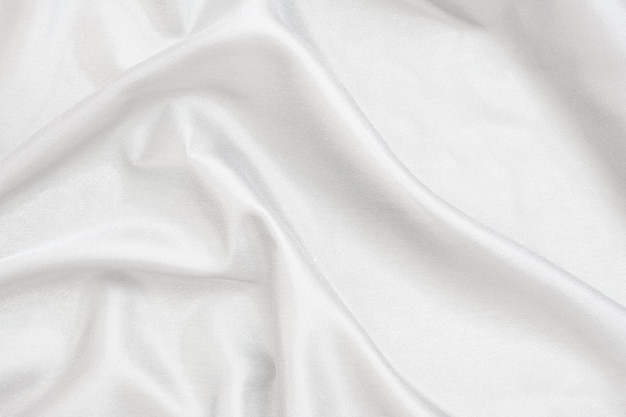 Smooth elegant white silk fabric or satin luxury cloth texture for abstract background