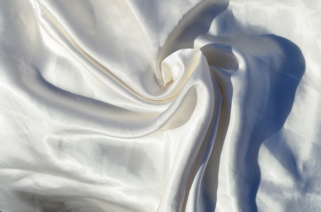 Smooth elegant white silk or satin luxury cloth texture can use as wedding background. Luxurious background design