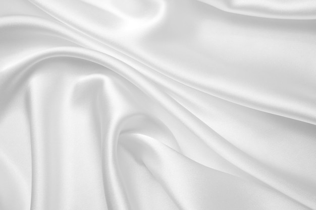 Smooth elegant white silk or satin luxury cloth texture can use as wedding background Luxurious Christmas background or New Year background design