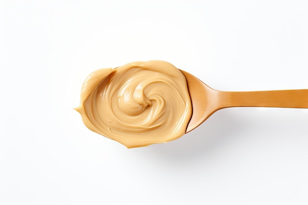 Smooth peanut butter on a spoon against a white background