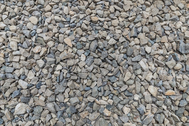 Smooth round pebbles texture background Pebble sea beach closeup dark wet pebble and gray dry pebble High quality photo