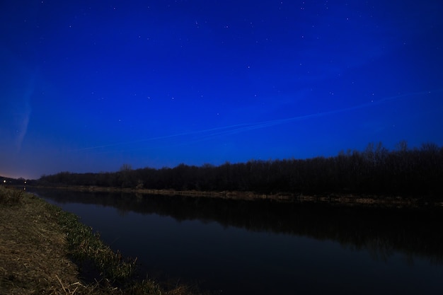 Smooth surface of the river on a background the starry sky