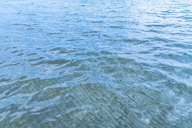 Foto superficie dell'acqua liscia con fondo di sabbia