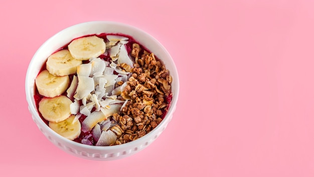 smoothie bowl with banana, granola and coconut flakes