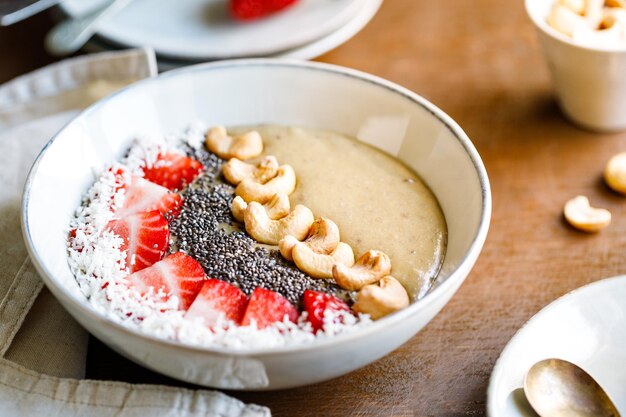 Smoothie bowl with banana matcha coconut cream strawberry cashew and chia seeds Healthy vegan eating