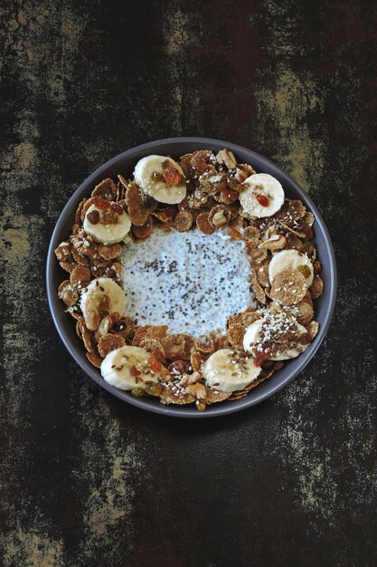 Photo smoothie bowl with banana, seeds and cereal. healthy breakfast or dessert.