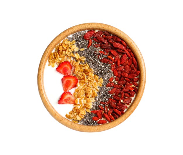 Smoothie bowl with goji berries on white background top view