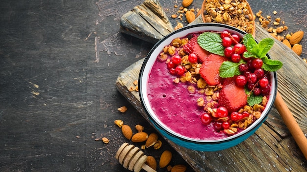 Smoothie bowl with granola strawberry red currants and mint Breakfast Top view Free space for your text