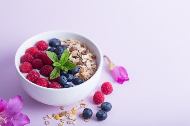 Smoothie bowl with yogurt, fresh berries and cereal