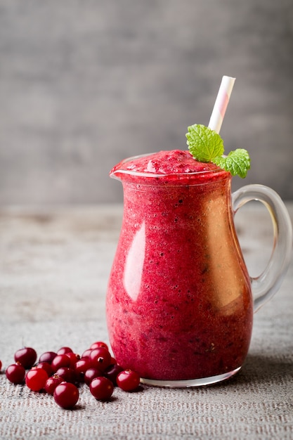 Smoothie, pink juice on the grey  background.