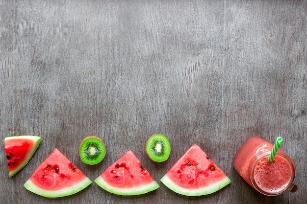 Smoothie of watermelon and kiwi on wooden background. Top view. Copy space. Still life. Flat lay