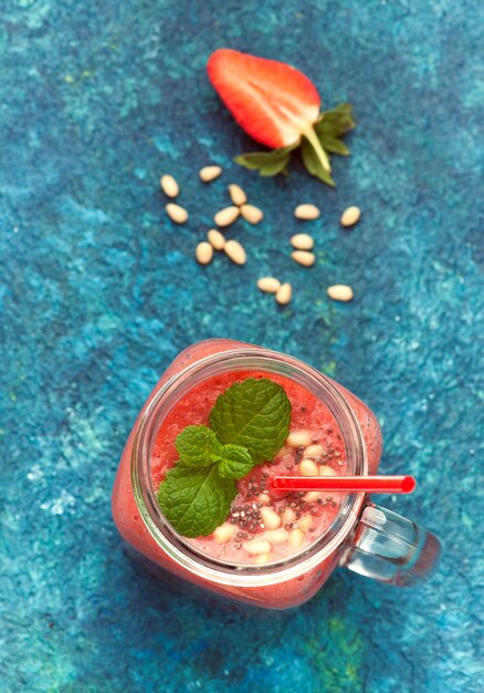 Smoothie with strawberries in glass jar