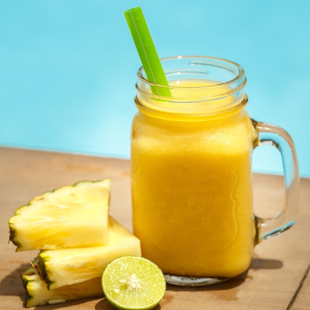 Smoothies in jar against the pool