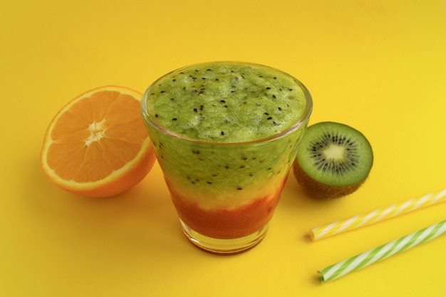 Smoothies with kiwi,orange and strawberry on the yellow