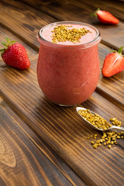 Smoothy with strawberry and bee pollen in glass jar