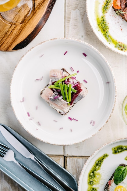 Smorrebrod a Danish open sandwich with herring and onion Top view