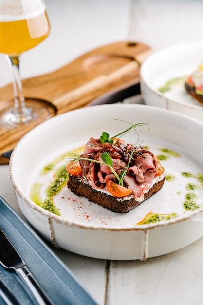 Smorrebrod Danish open sandwich with roast beef sweet onion and cherry tomato