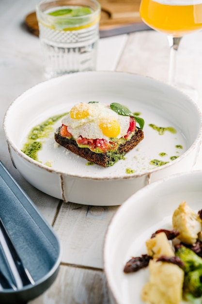 Smorrebrod Danish open sandwich with salmon egg avocado and cilantro sauce