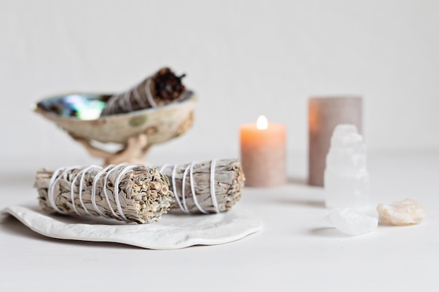 Smudge kit with white sage stick, abalone sea shell. Natural elements for cleansing environment from negative energy, adding positive vibes. Spriritual practices, witchcraft concept