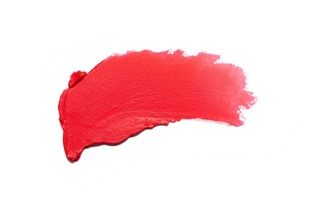 Smudged red matte lipstick swatch isolated on white background