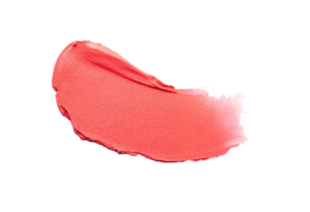 Smudged red orange matte lipstick swatch isolated on white background