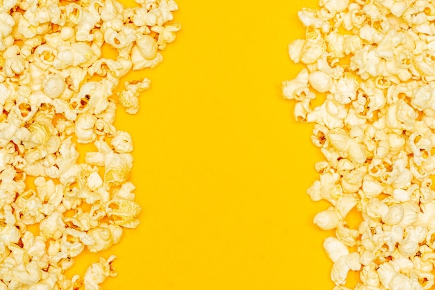 Snack concept Sweet popcorn and salty popcorn with empty space in a yellow background