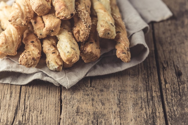 Snack of grissini bread sticks on a wooden background tapas bar\
homemade bread sticks toned