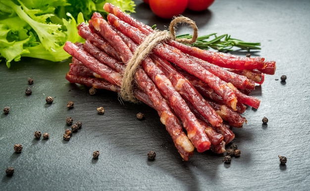 Snack stick sausages on a wooden table