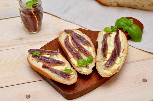 Snack toast with fish on a board closeup