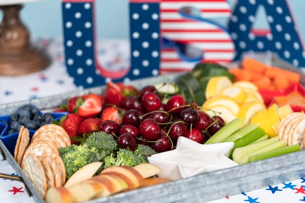 Snack tray with fresh fruits, vegetables, and dips at the July 4th celebration party.