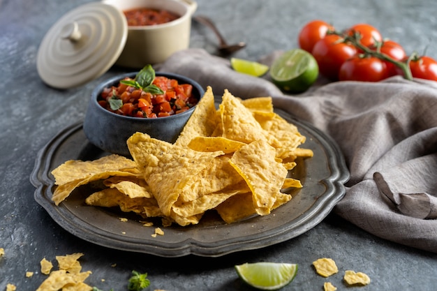 Snack voor een feest, mexicaanse gerechten nachos tortillachips en sipping salsa met tomaat.