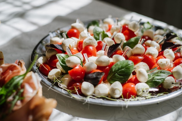 Snack with cheese balls and tomatoes on the buffet table