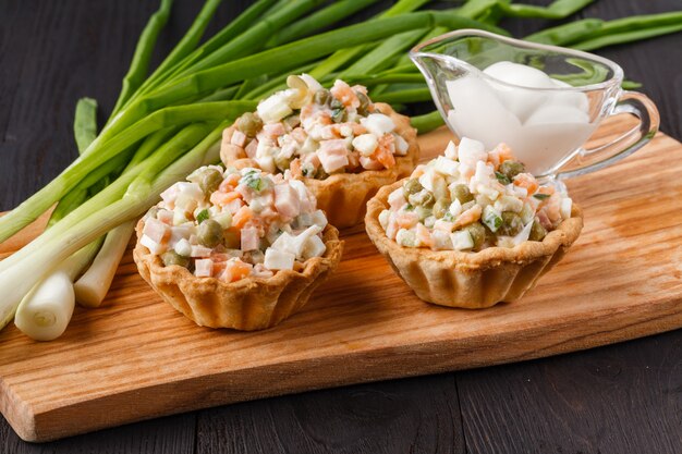 Snack with ham, cheese, pepper and tomato in tartlets. Square. Concept of food, restaurant, catering, menu