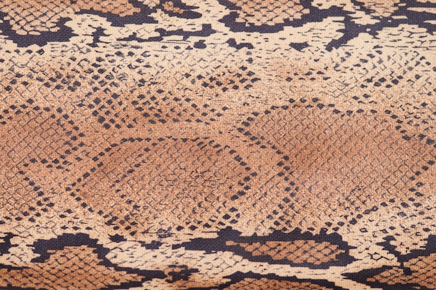 Snake skin background, close up, beige and brown texture