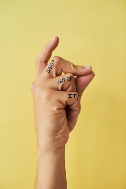 Snap out of it Studio shot of an unrecognizable man snapping his fingers against a yellow background