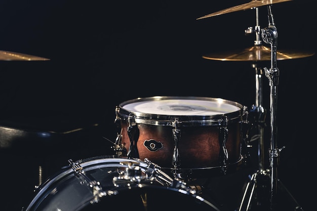 Snare drum on a blurred dark background part of a drum kit