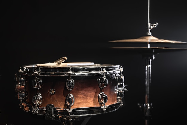 Snare drum and hi hat on a dark background, copy space.