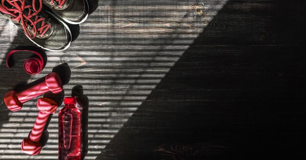 Sneakers dumbbells and a bottle of water. Flat view. All in one color.