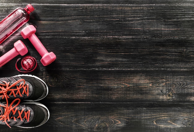 Photo sneakers dumbbells and a bottle of water. flat view. all in one color.