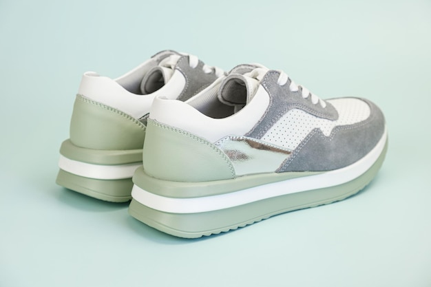 Sneakers for everyday use on a pale green background