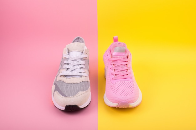 Sneakers lie on a multi-colored pastel surface